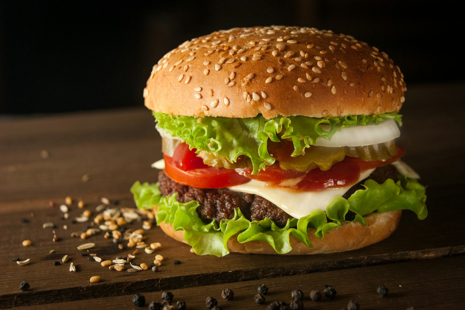 Stock photo of a charbroiled cheeseburger on dark wood — placeholder, not their kitchen