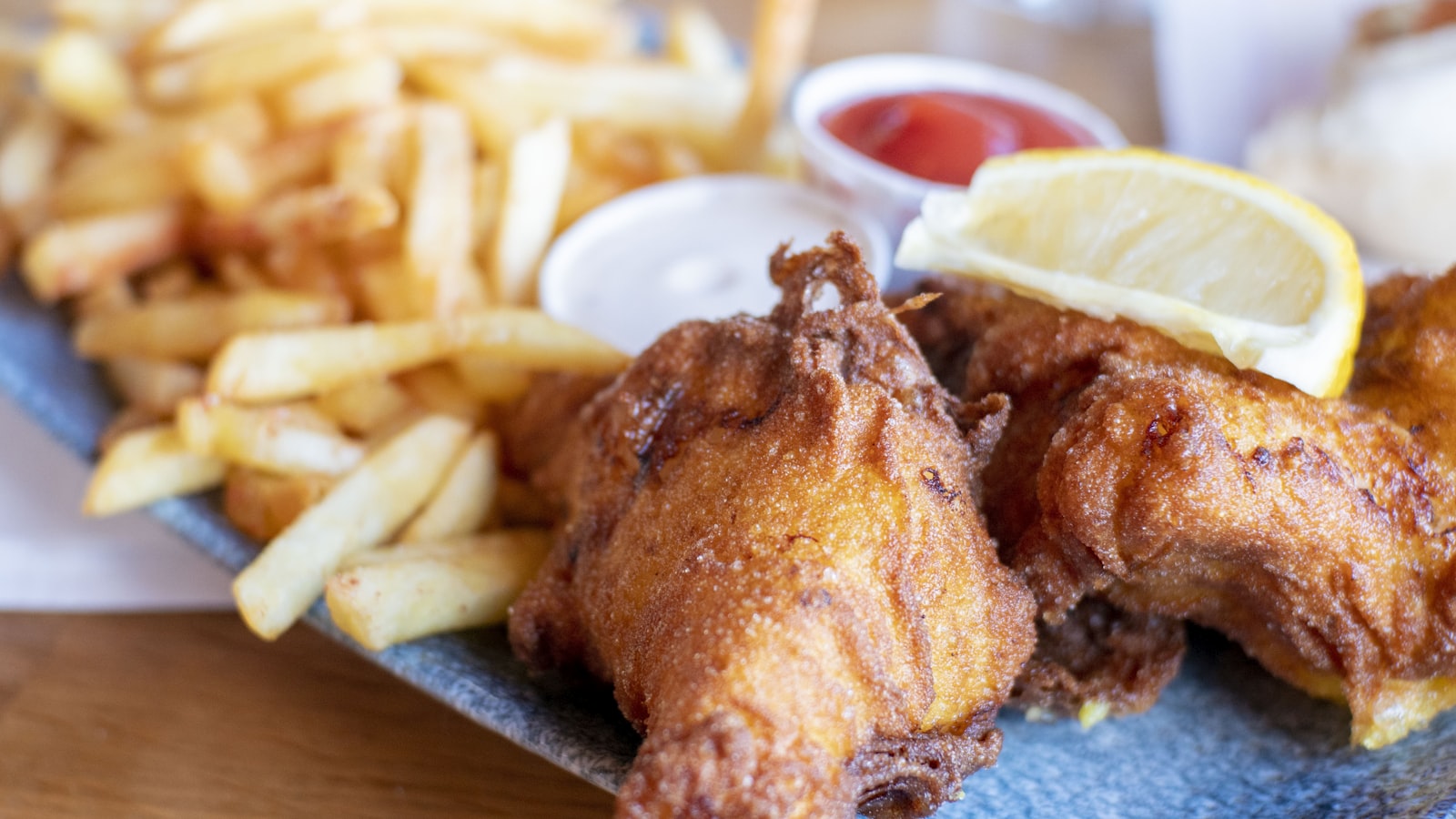 Stock photo of battered fish and chips with lemon — placeholder, not their kitchen
