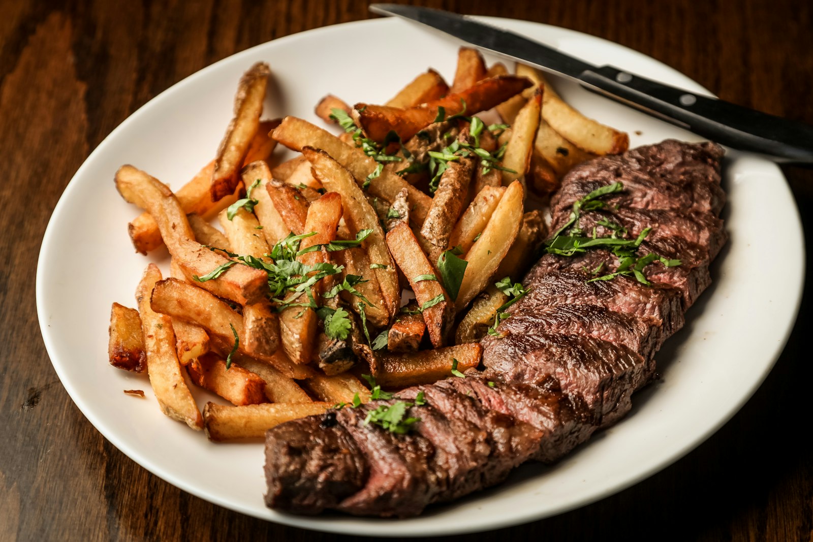 Stock photo of steak and fries on a plate — placeholder, not their kitchen